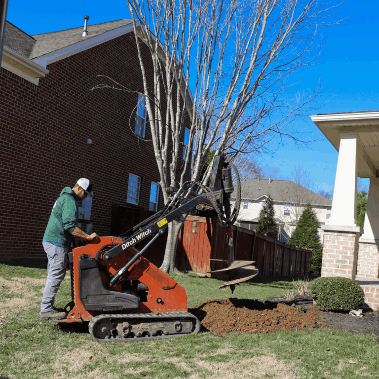 Stump grinding machine clearing a residential yard in West Meade, Nashville