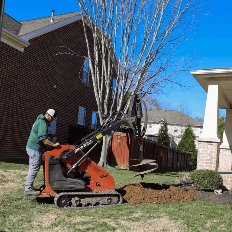 Stump grinding machine clearing a residential yard in West Meade, Nashville